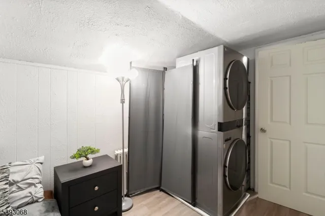 a view of a bathroom with shower and mirror
