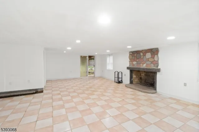 a view of an empty room with a fireplace