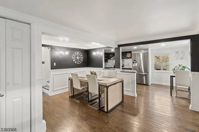 a open kitchen with white cabinets and stainless steel appliances