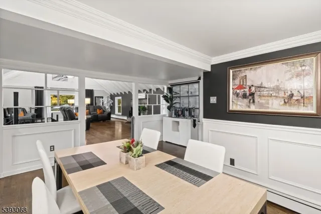 a living room with furniture a rug and wall painting
