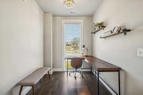 a kitchen with a stove a table and chairs