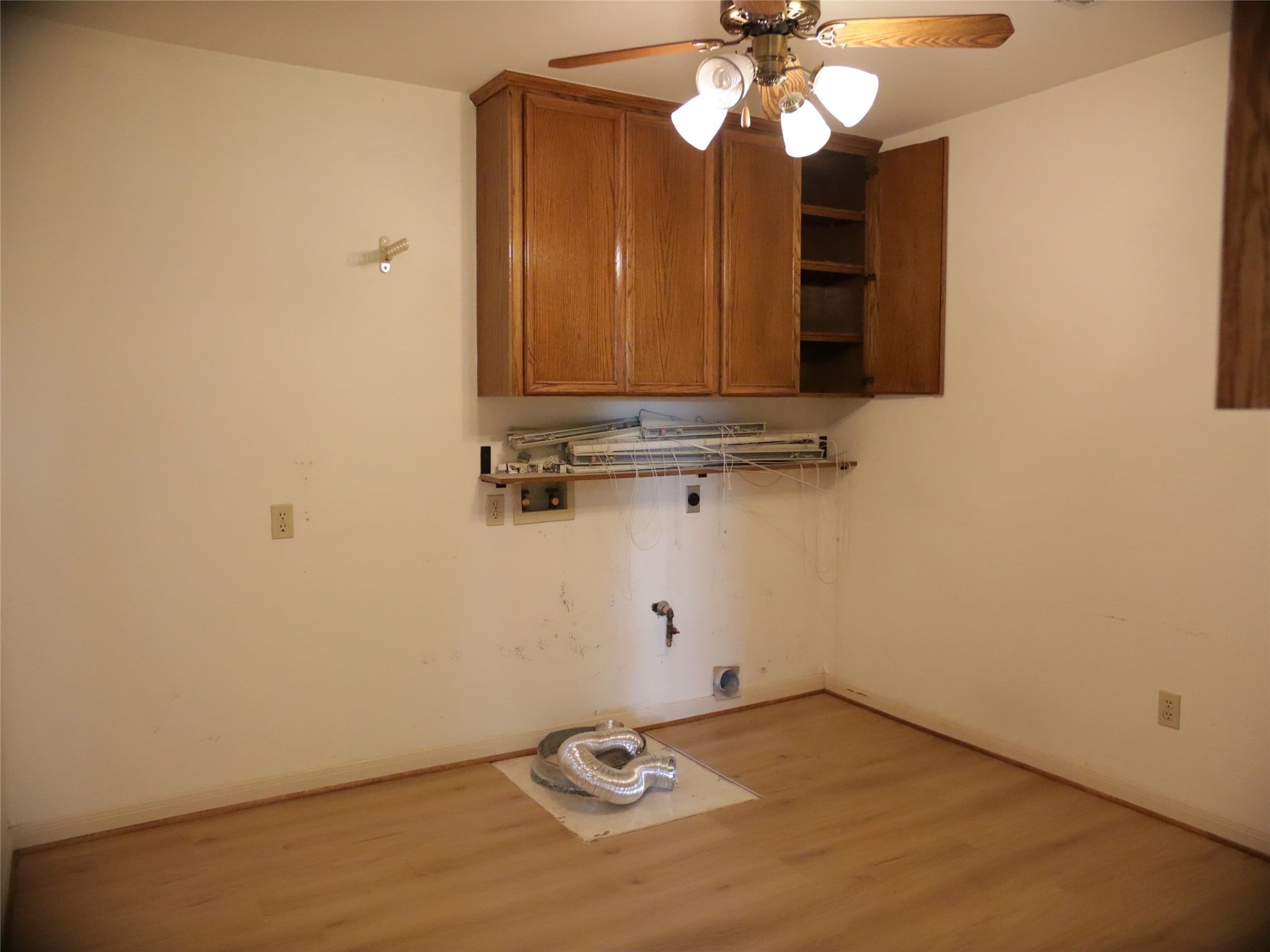 1612 Buttercup Road Pflugerville, TX 78660 - Photo 14 of 16 Functional laundry space with ready-to-use hookups and ample overhead storage.
