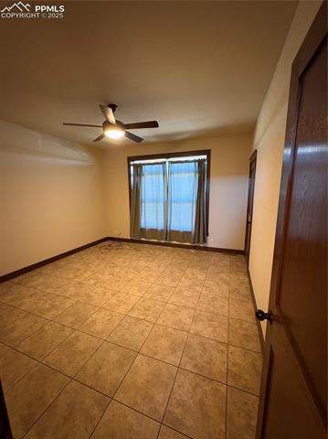 1925 Doe Valley Road Guffey, CO 80820 - Photo 16 of 30 Unfurnished room with light tile patterned floors and ceiling fan