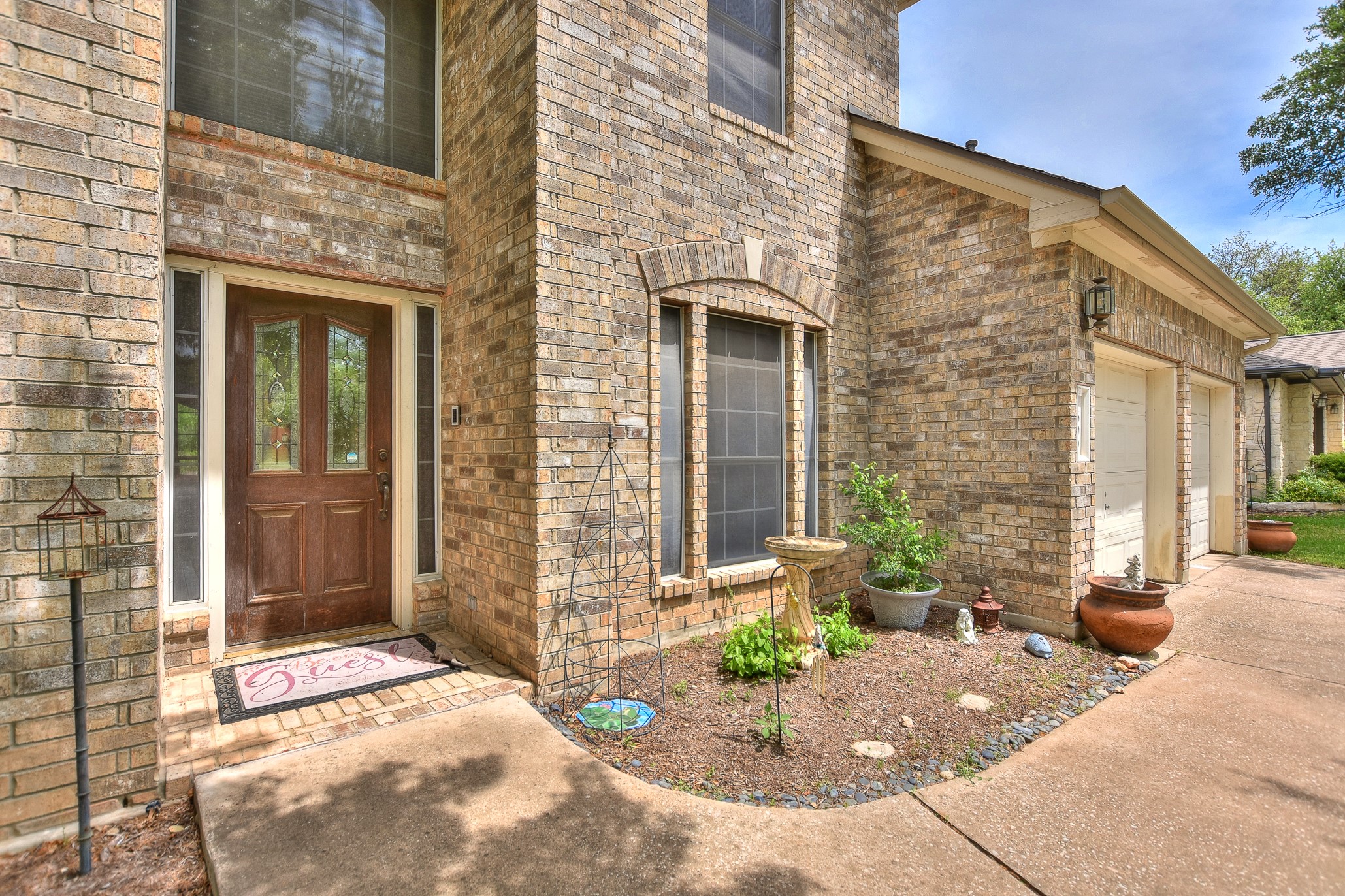 1609 Colton Way Cedar Park, TX 78613 - Photo 3 of 24 A classic brick facade welcomes visitors, featuring a charming wooden front door and an integrated garage.