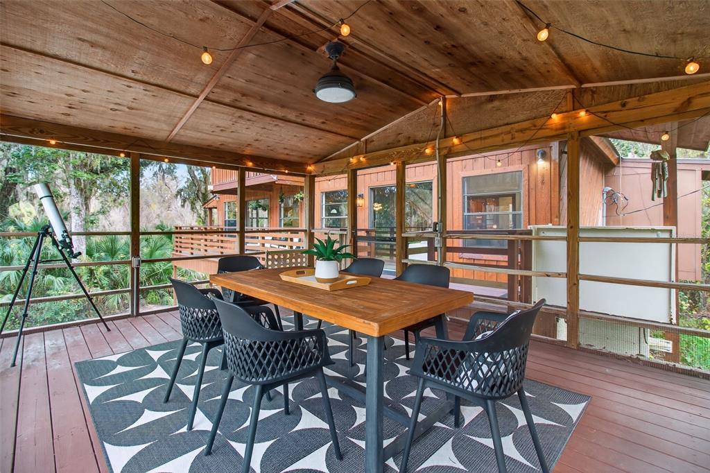4925 Hamilton Road Lakeland, FL 33811 - Photo 29 of 71 a table and chairs with wooden floor in front of a house