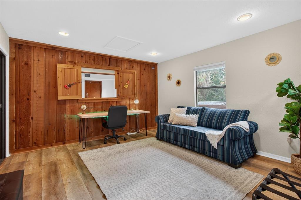 4925 Hamilton Road Lakeland, FL 33811 - Photo 35 of 71 a living room with furniture a piano and a potted plant