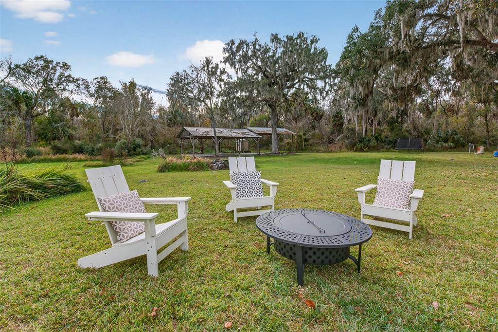 4925 Hamilton Road Lakeland, FL 33811 - Photo 53 of 71 a view of a swimming pool and lounge chairs in back yard of the house