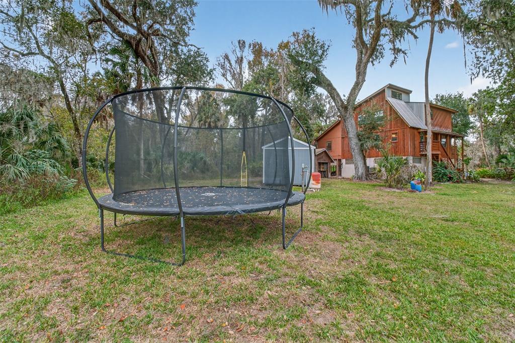 4925 Hamilton Road Lakeland, FL 33811 - Photo 58 of 71 a backyard of a house with table and chairs
