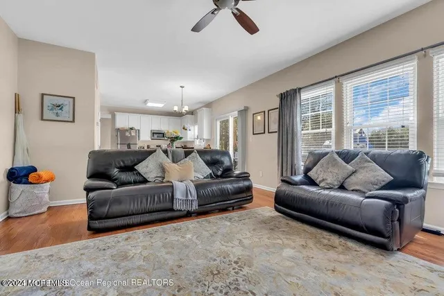 a living room with furniture and a ceiling fan