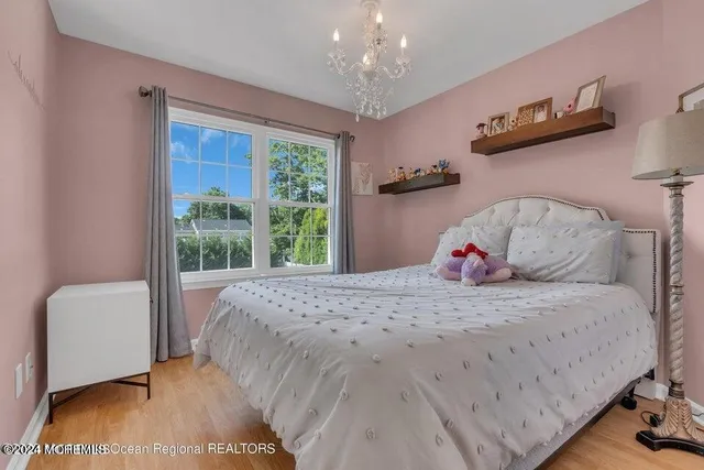 a bedroom with a bed and large windows