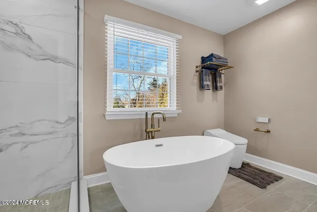 a white bath tub sitting next to a white sink