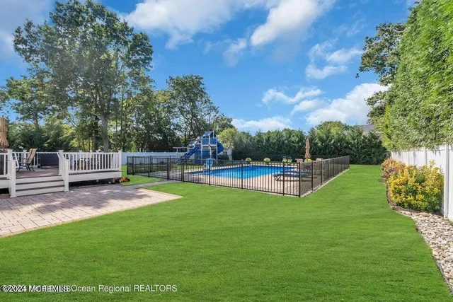 a view of a garden with wooden fence