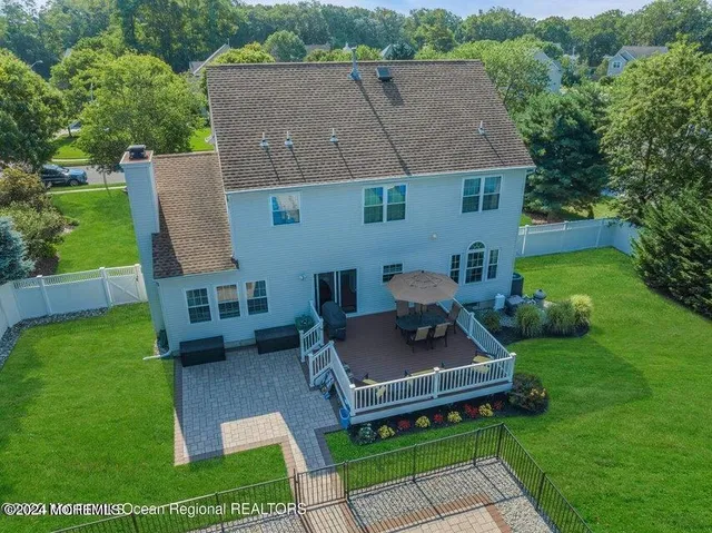a aerial view of a house with a yard patio and fire pit