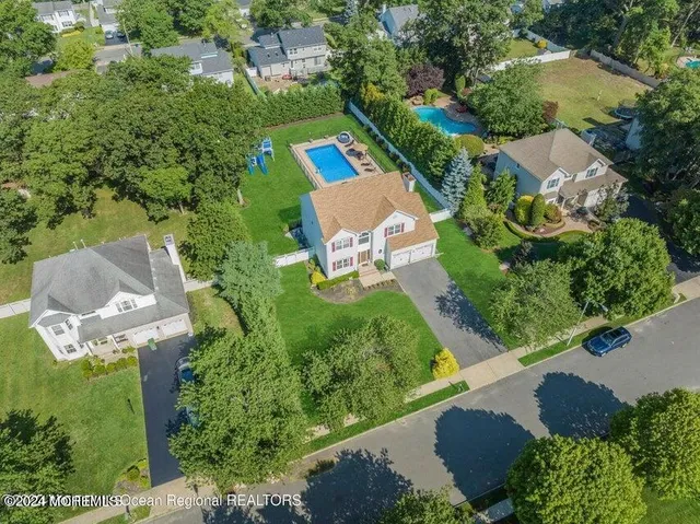 an aerial view of a house with yard swimming pool and outdoor seating