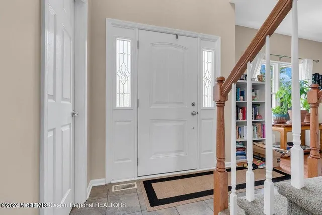 a view of an entryway with wooden floor