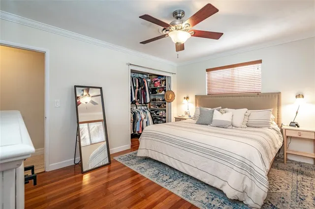 a bedroom with a large bed and a window