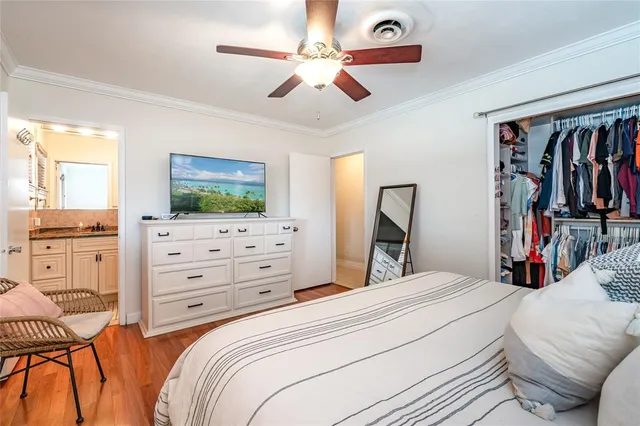 a bedroom with a bed dresser and flat screen tv
