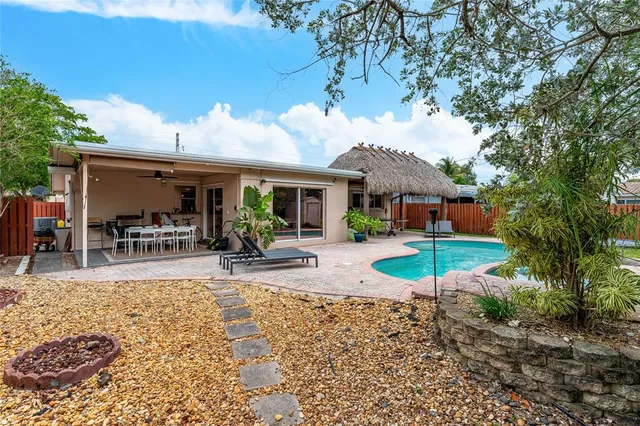 a view of a house with backyard porch and sitting area