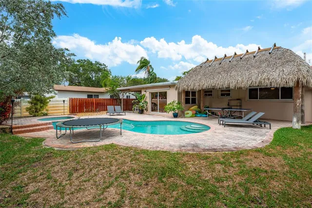 an aerial view of a house with swimming pool garden and patio