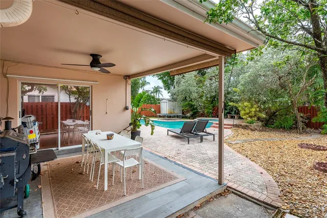 a view of a patio with a table chairs and a backyard