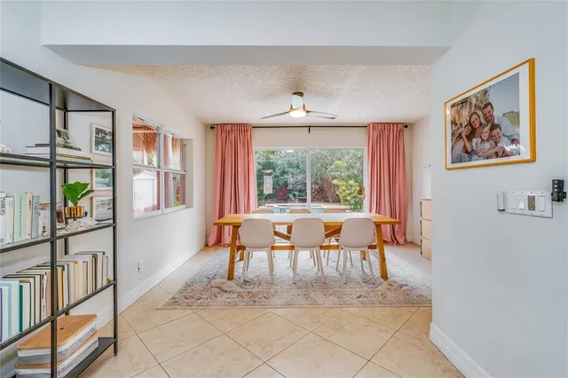 a living room with furniture a window and a painting on the wall