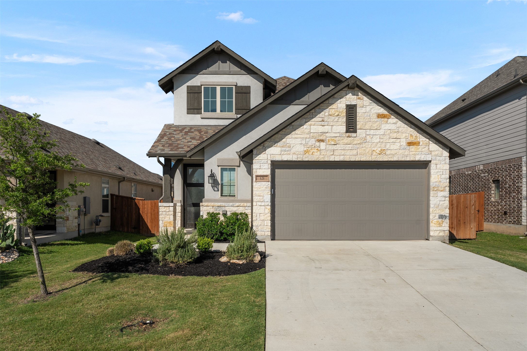 a front view of a house with a yard and garage