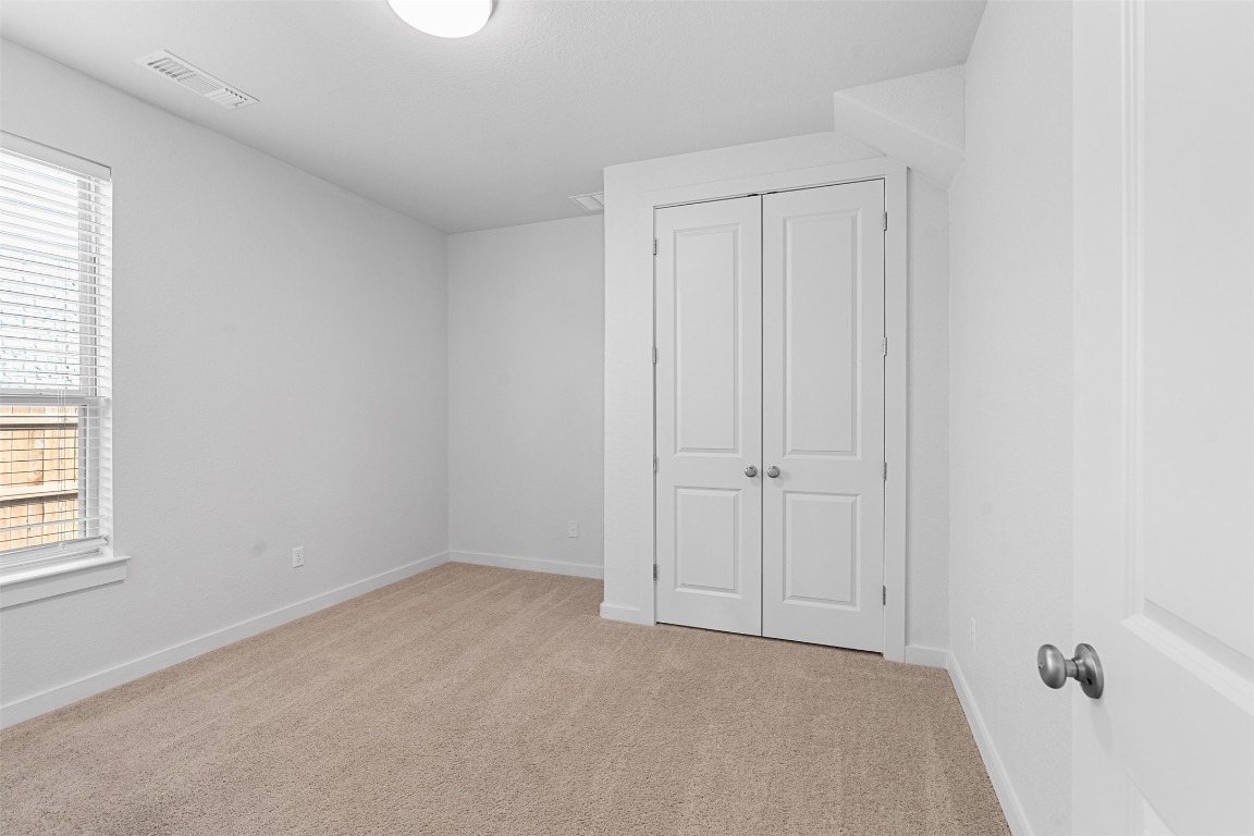 121 Rangel Drive Liberty Hill, TX 78642 - Photo 14 of 23 an empty room with windows