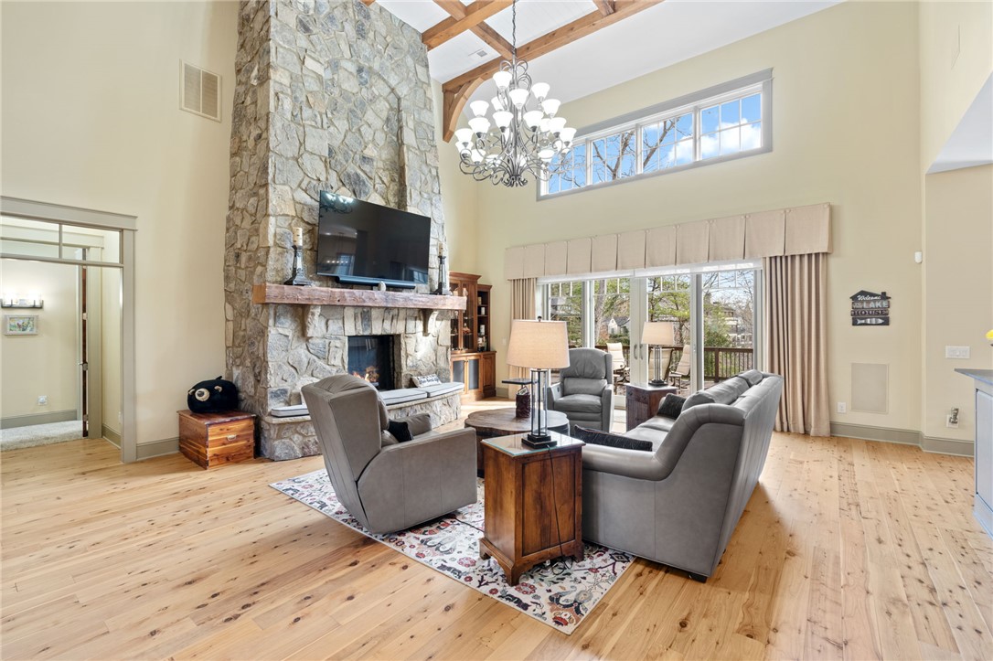 117 Sunrise Ridge Sunset, SC 29685 - Photo 5 of 37 This living area features a grand stone fireplace and direct outdoor access through expansive glass doors.