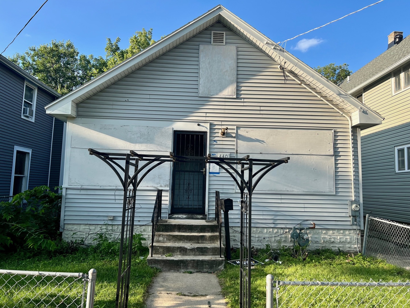 440 Center Avenue Aurora, IL 60505 - Photo 3 of 4 a view of a house with wooden walls stairs and a large tree