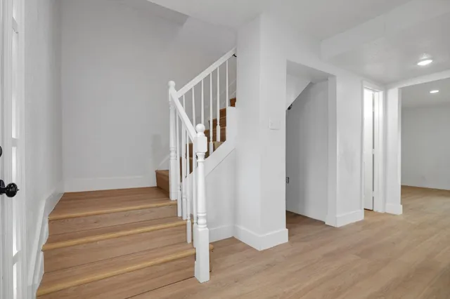 a view of entryway and hall with wooden floor