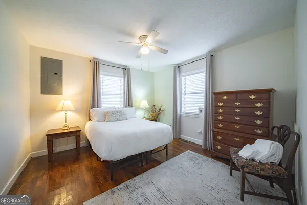 a living room with furniture and a lamp