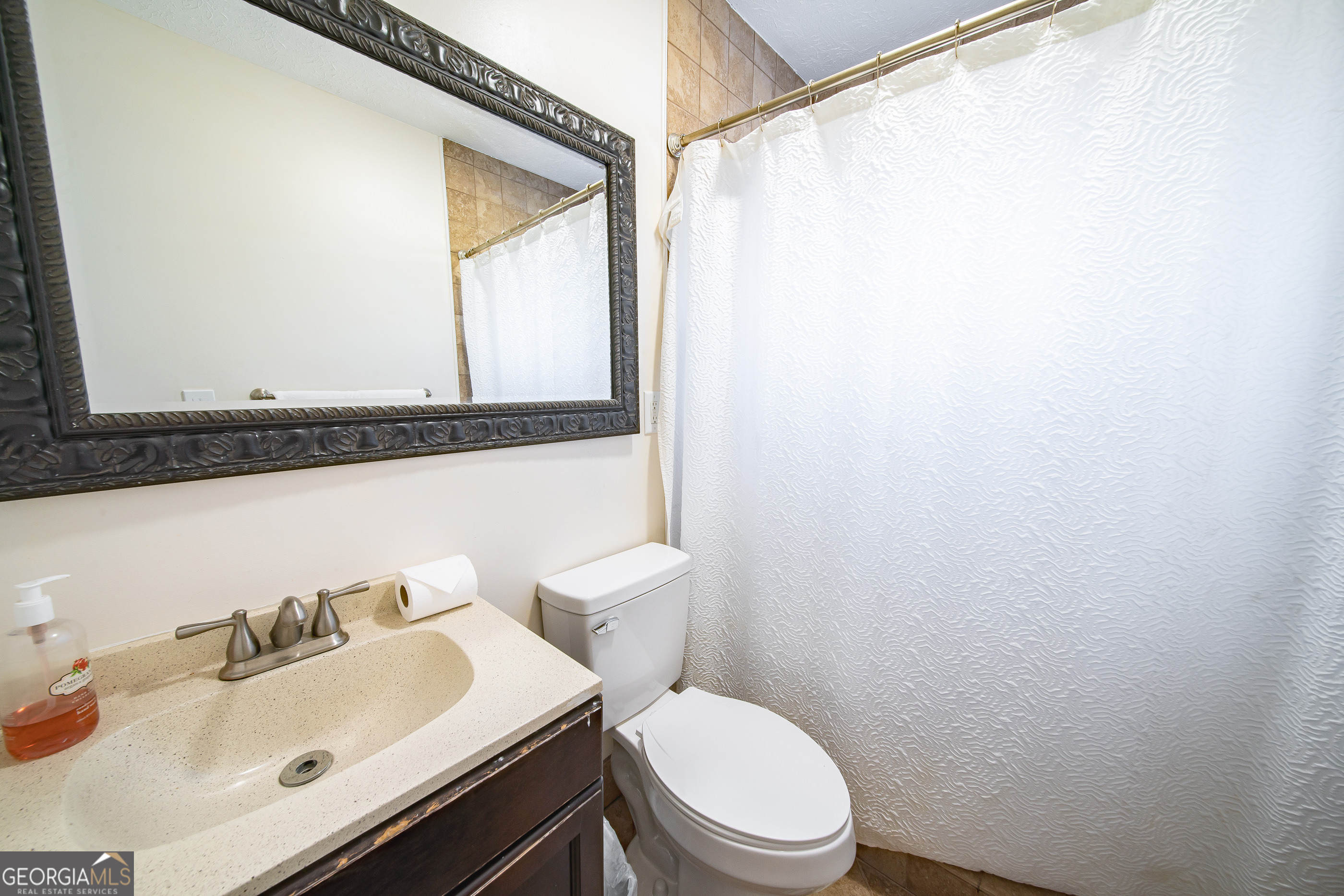 161 Calhoun Road Hamilton, GA 31811 - Photo 35 of 90 a bathroom with a sink vanity mirror and toilet