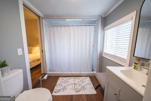 a bed sitting in a bedroom next to a window