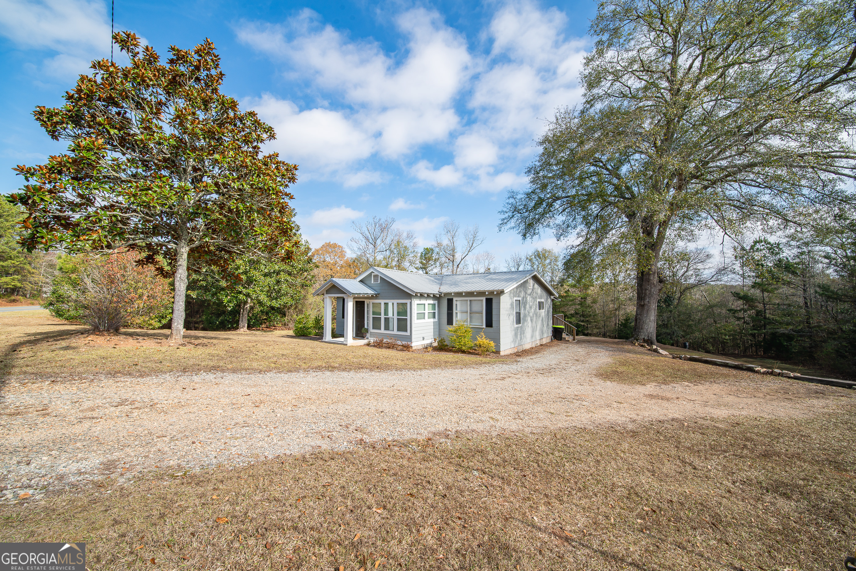 161 Calhoun Road Hamilton, GA 31811 - Photo 5 of 90 a front view of a house with a yard and trees