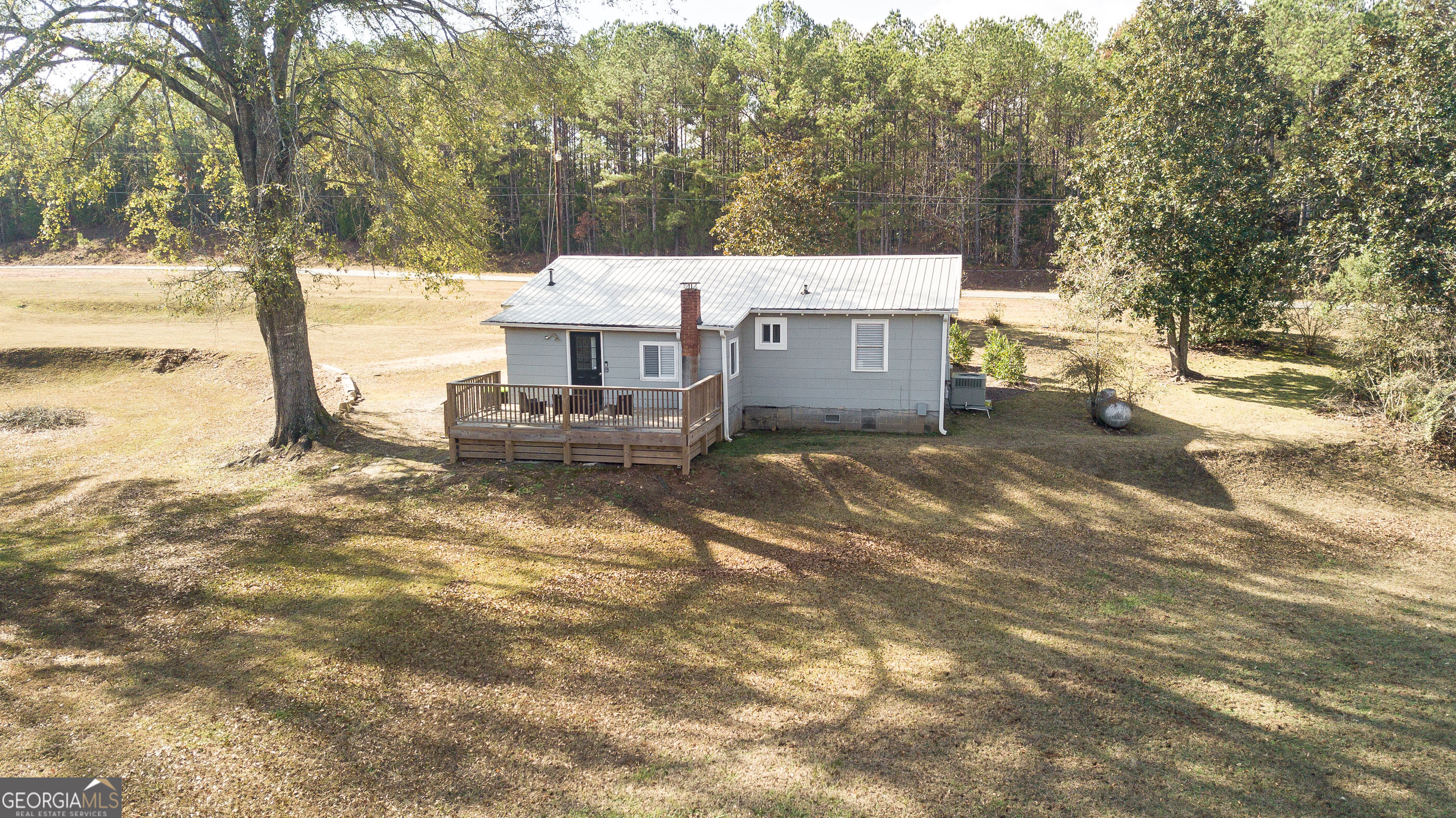 161 Calhoun Road Hamilton, GA 31811 - Photo 54 of 90 a view of a house with a yard covered with snow in the background