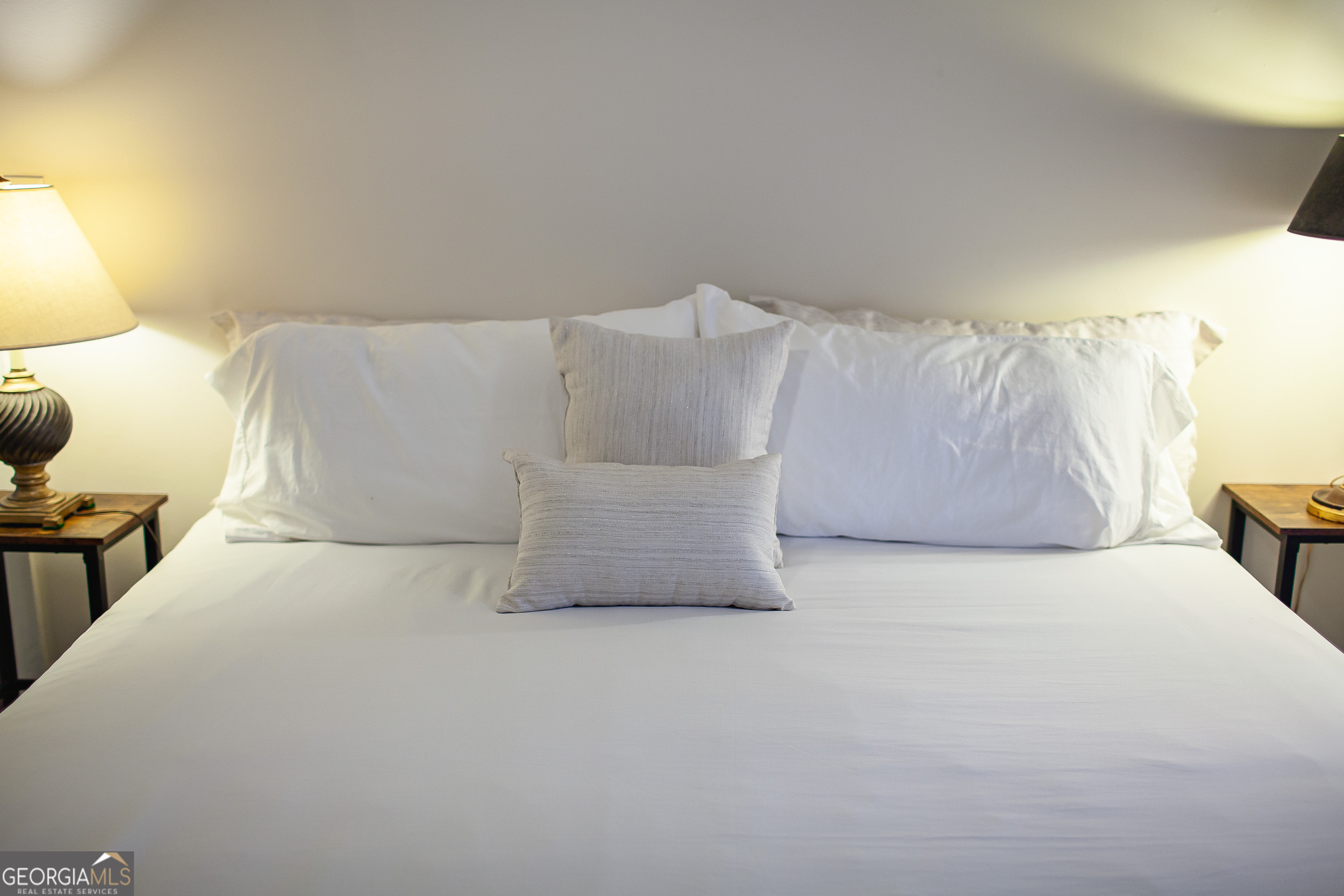 161 Calhoun Road Hamilton, GA 31811 - Photo 75 of 90 a white bed sitting in a room next to a lamp