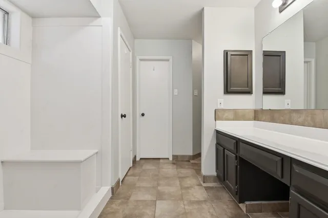a view of walk in closet with empty racks