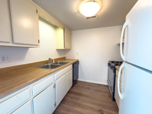 a view of a kitchen with a sink and dishwasher