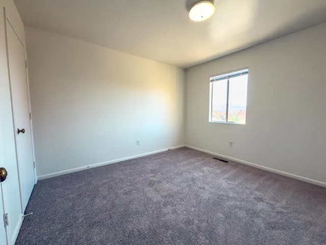 an empty room with windows and entrance