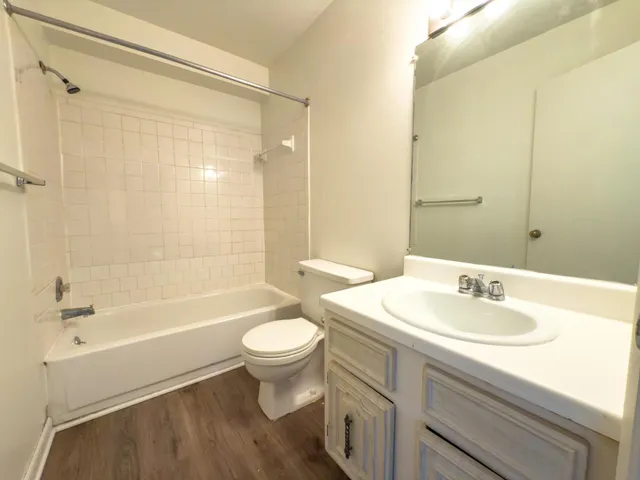 a bathroom with a sink toilet a mirror and shower