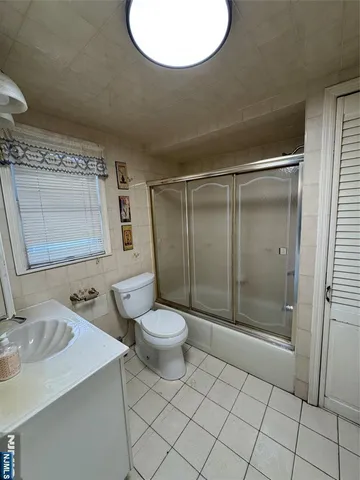 a bathroom with a toilet sink and shower