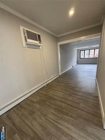 a view of an empty room and wooden floor