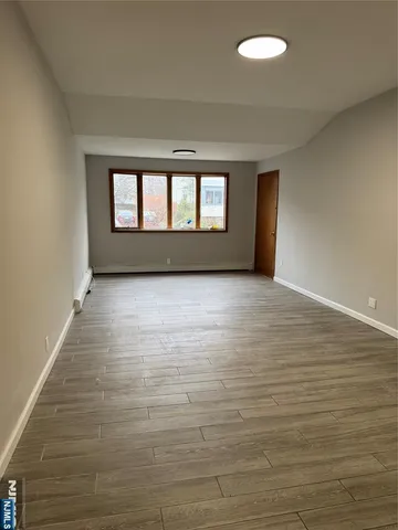 a view of an empty room with glass door