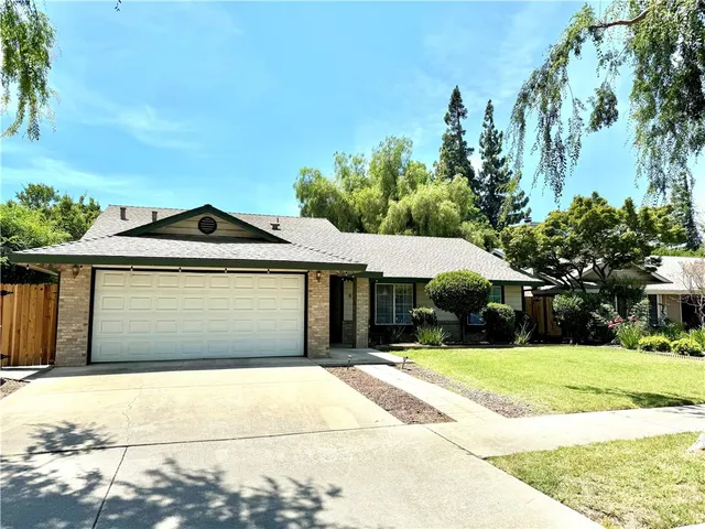 a front view of a house with yard and garage