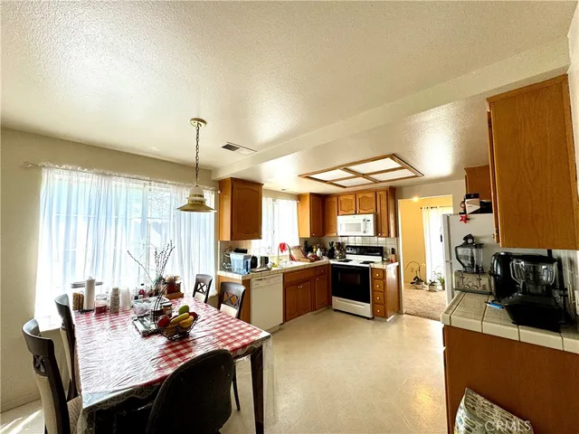 a large kitchen with a table and chairs