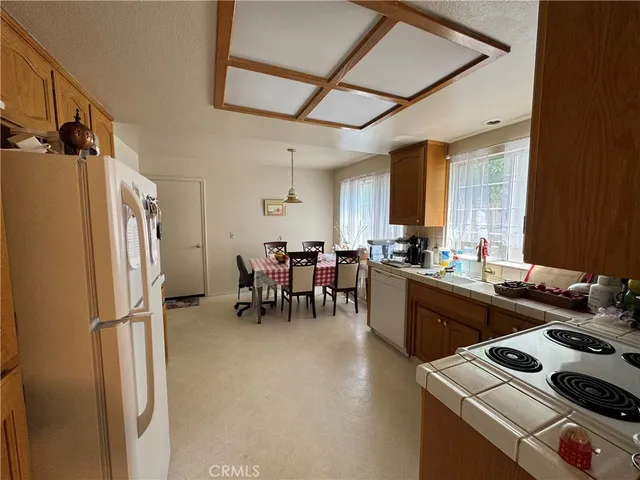 a kitchen with furniture a refrigerator and a sink