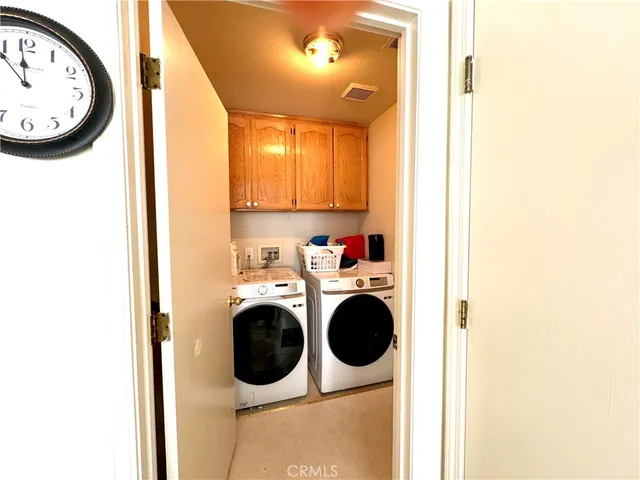 a view of a bedroom with washer and dryer