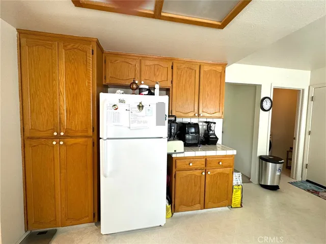 a utility room with refrigerator and washer
