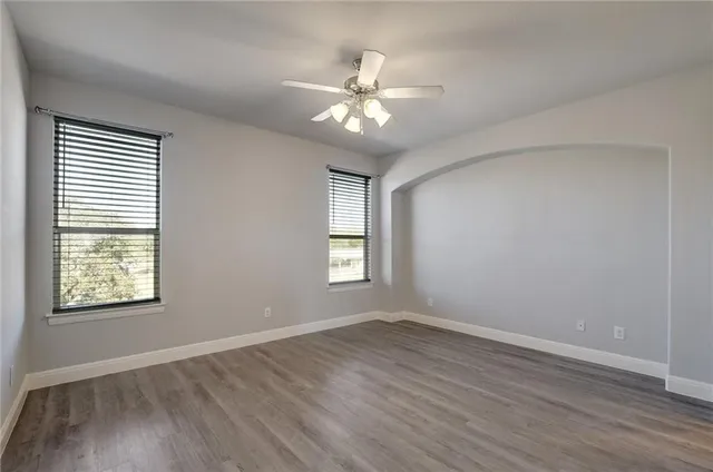 a view of an empty room with wooden floor