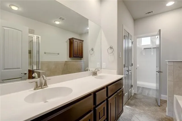 a bathroom with a bathtub and a shower